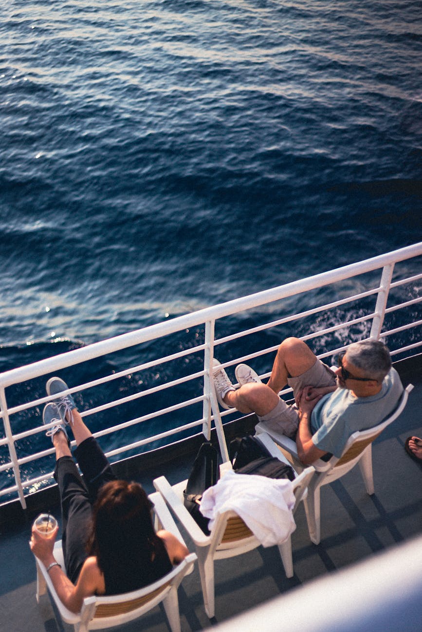 couple sitting on a luxury cruise deck relaxing